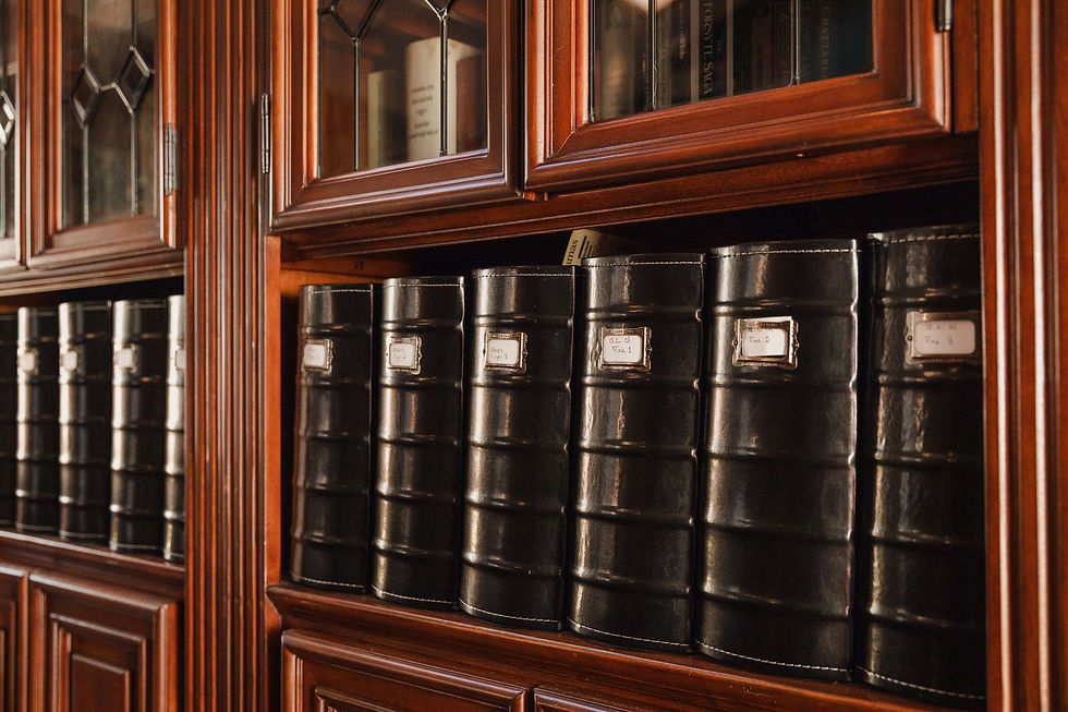 A row of black 3-ring binders in a bookcase