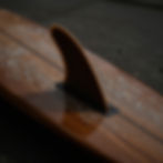 Close-up of a wooden surfboard fin at a Pompano Beach kava bar