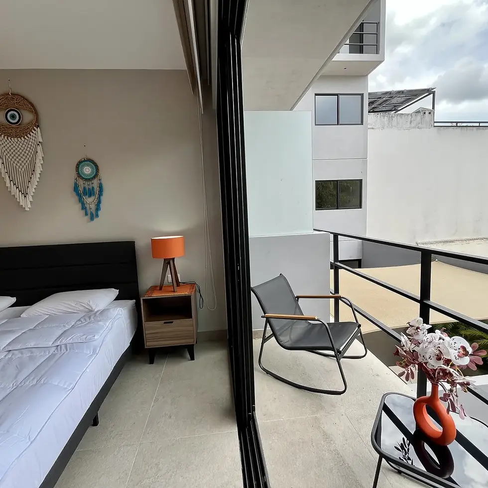 Furnished bedroom with balcony and staged decor