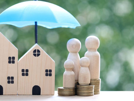 Family insurance protection concept with house, coins, and umbrella 