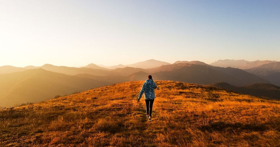 Woman hiking during fall sunrise