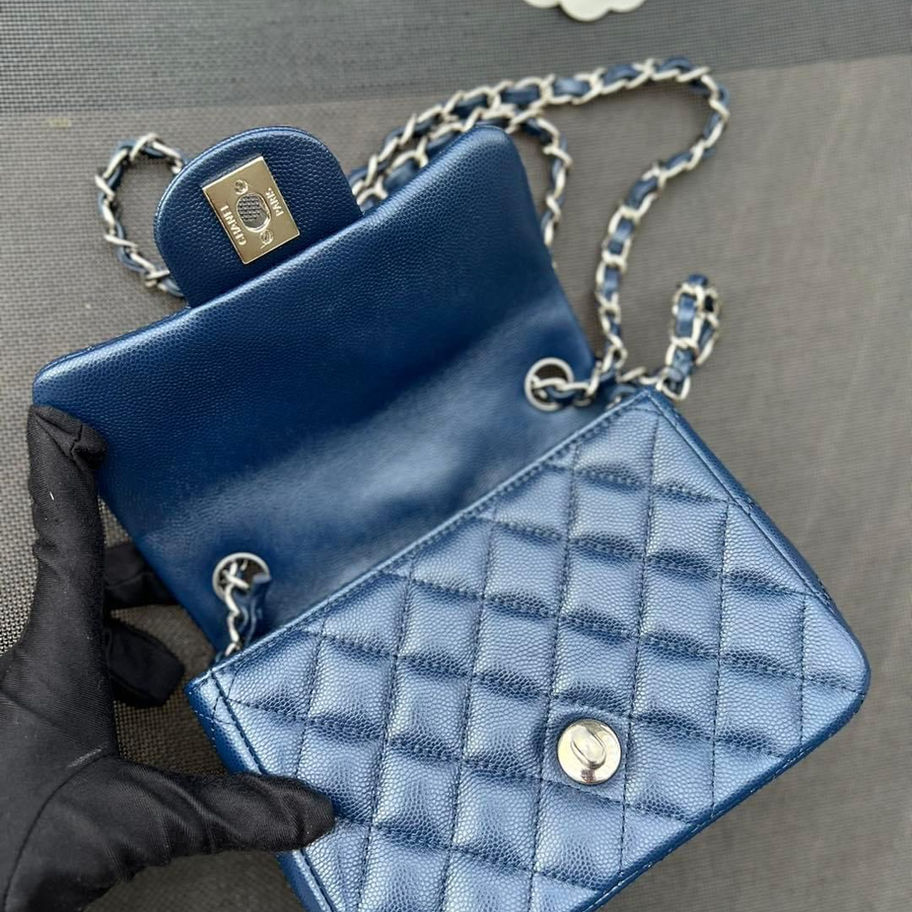 Blue quilted Chanel handbag with silver chain