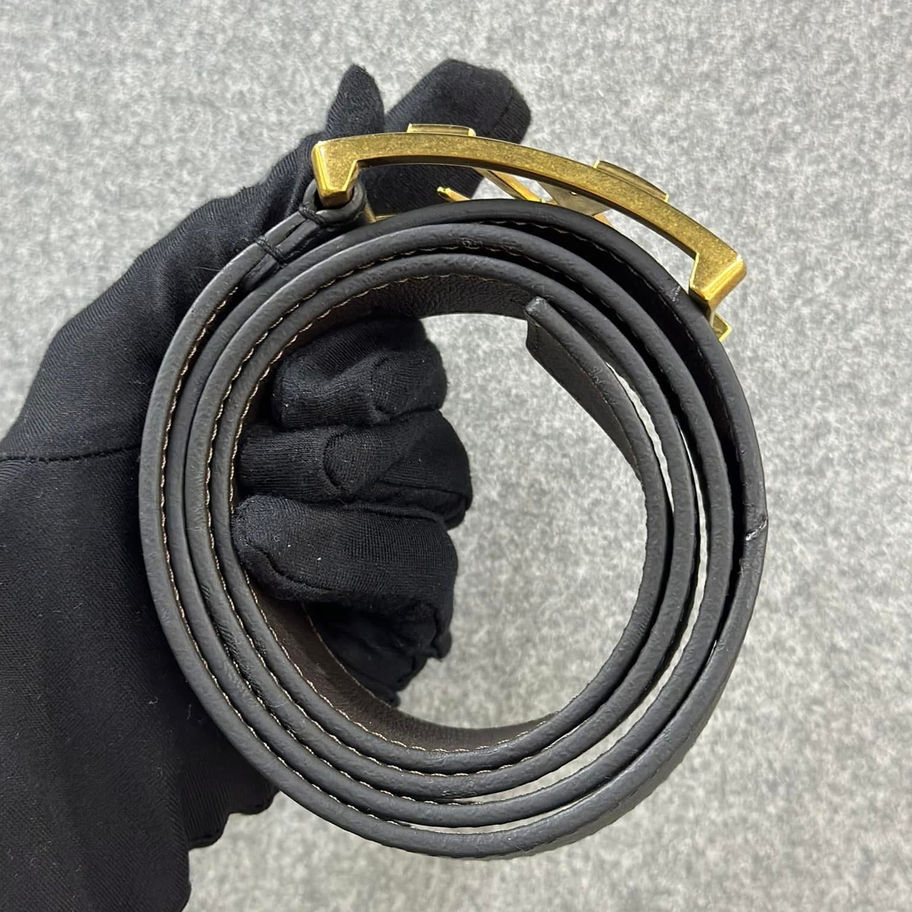 Rolled dark brown leather belt with gold buckle