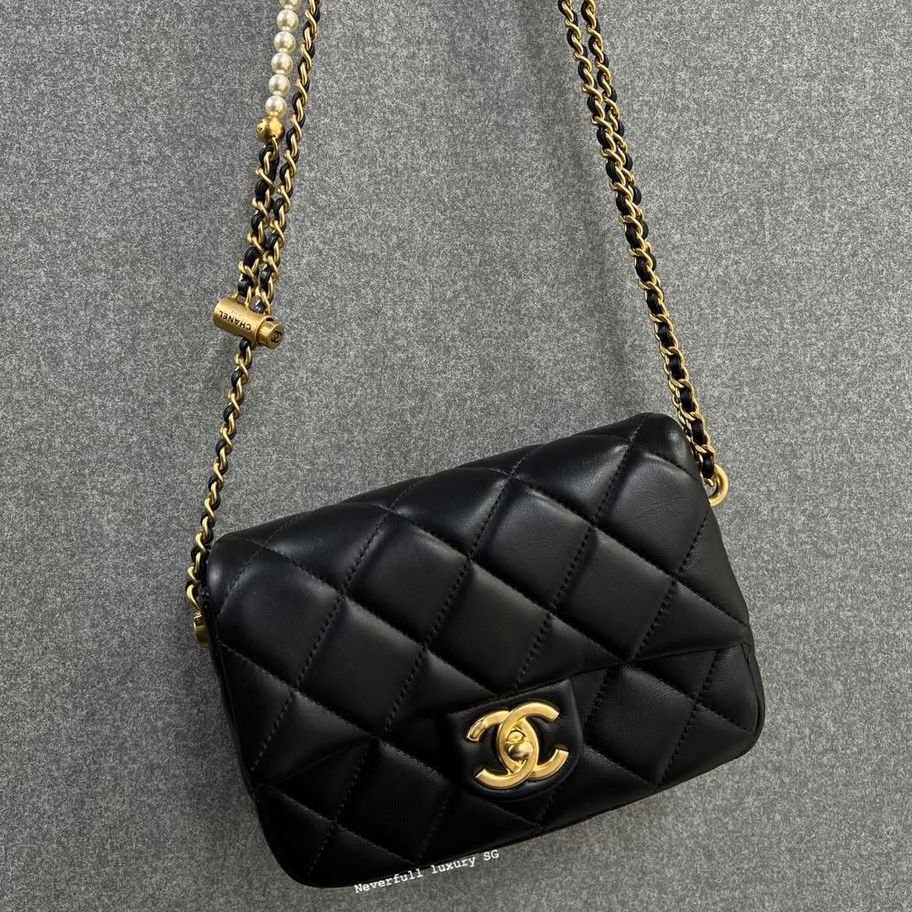 Black quilted Chanel mini flap bag with gold chain strap