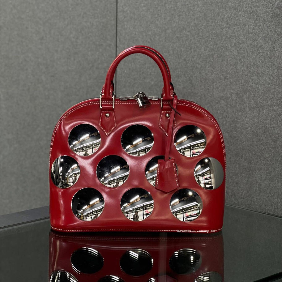 Red Louis Vuitton Montaigne handbag with circular cutouts