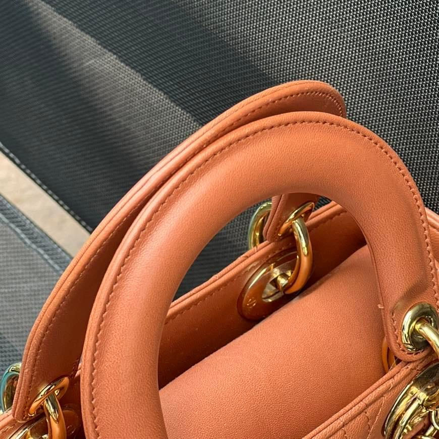 Close-up of a burnt orange leather handbag