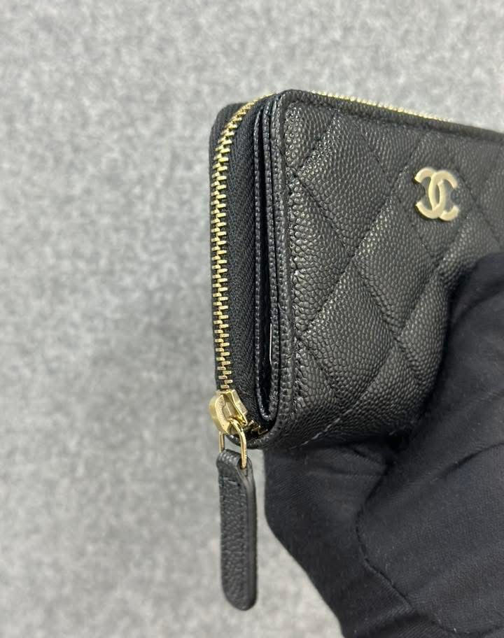 Black quilted Chanel wallet with gold zipper