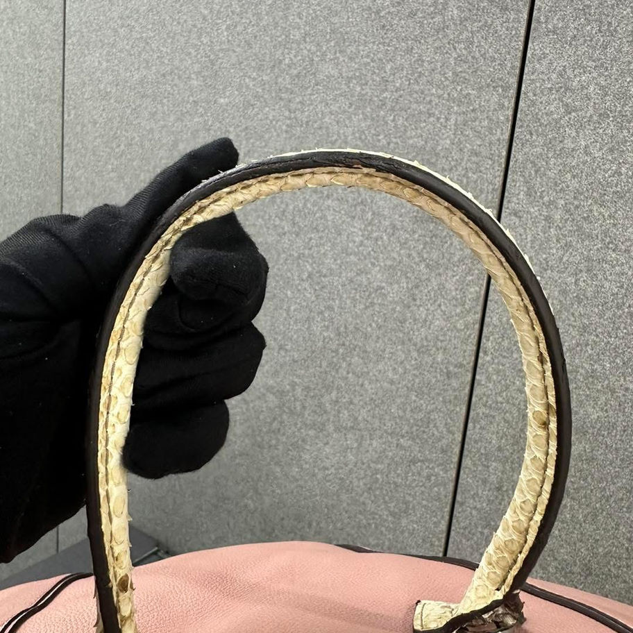 Close-up of worn Louis Vuitton handbag handle