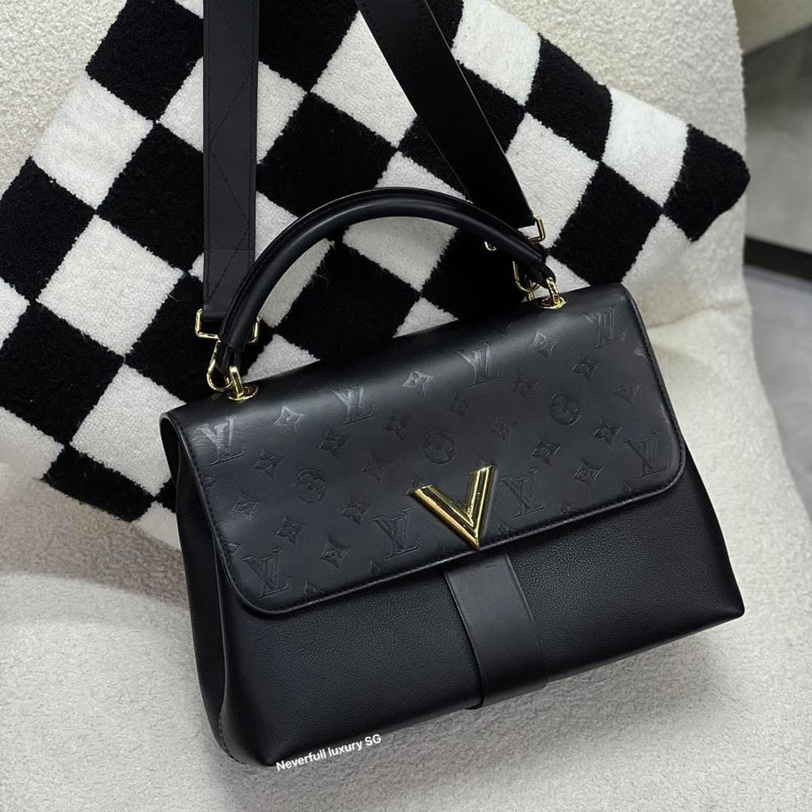 Black leather handbag with gold accents