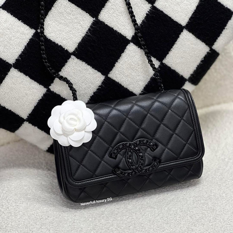 Black quilted Chanel handbag with camellia