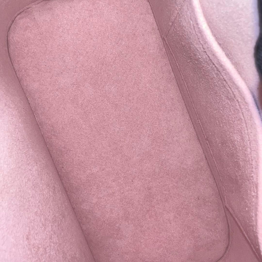Pink fabric interior of a handbag