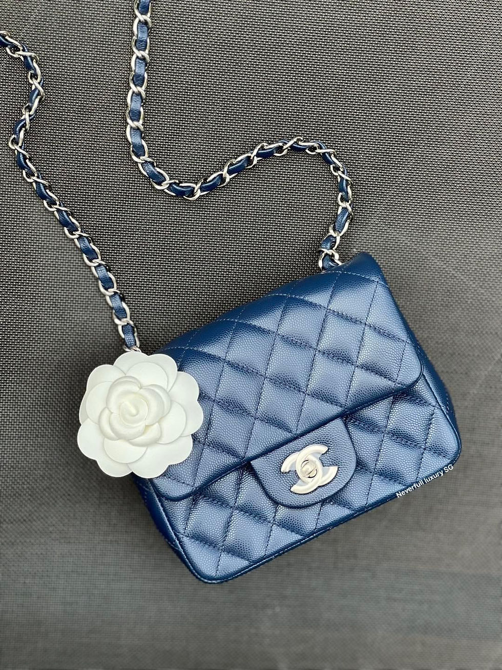 Navy Chanel handbag with white flower