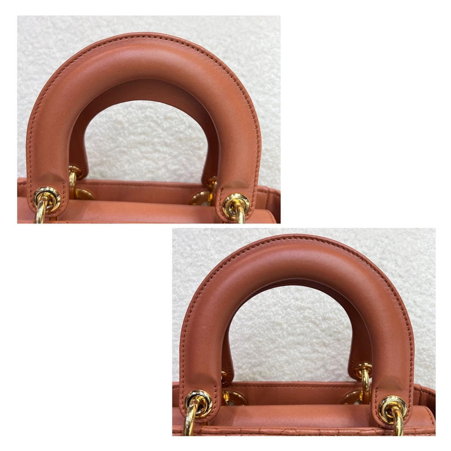 Close-up of a salmon-pink handbag's top handle