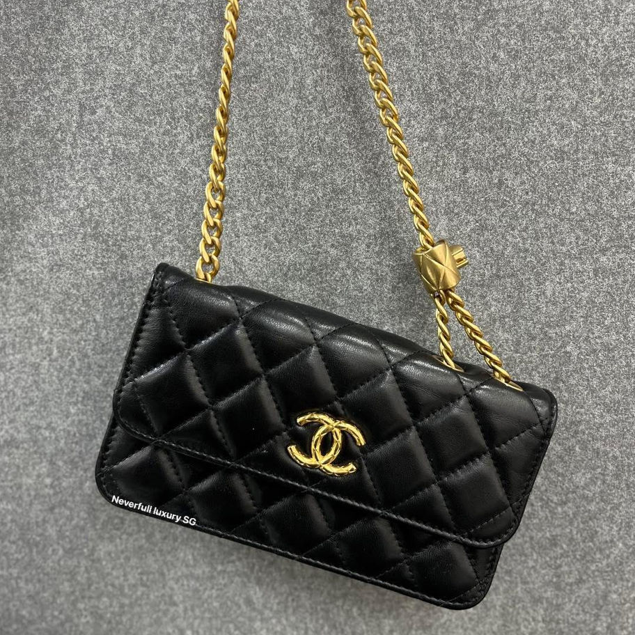 Black quilted Chanel mini bag with gold chain