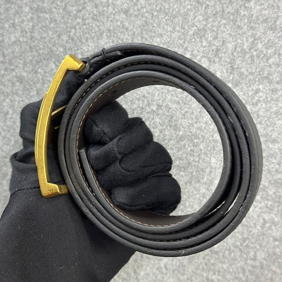 Black leather belt with gold buckle