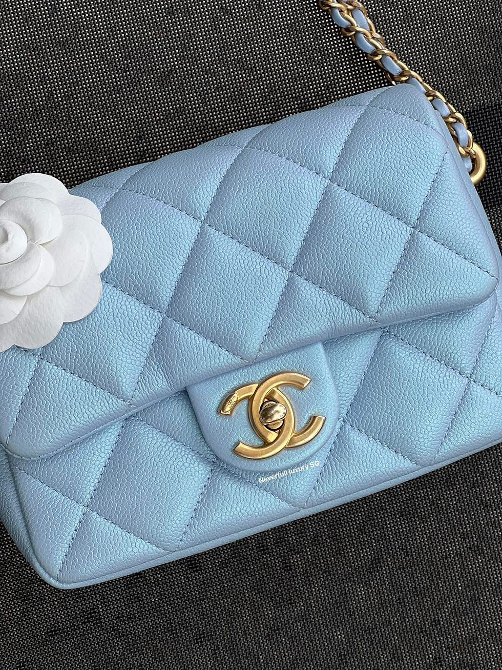 Pale blue Chanel handbag with camellia