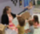 Art class where children are looking at a cardboard gorilla presented by the teacher