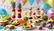 Mesa de festa infantil com comidas saudáveis e coloridas como espetadas de fruta, muffins de legumes e sanduíches divertidas, decorada com balões pastel ao fundo.
