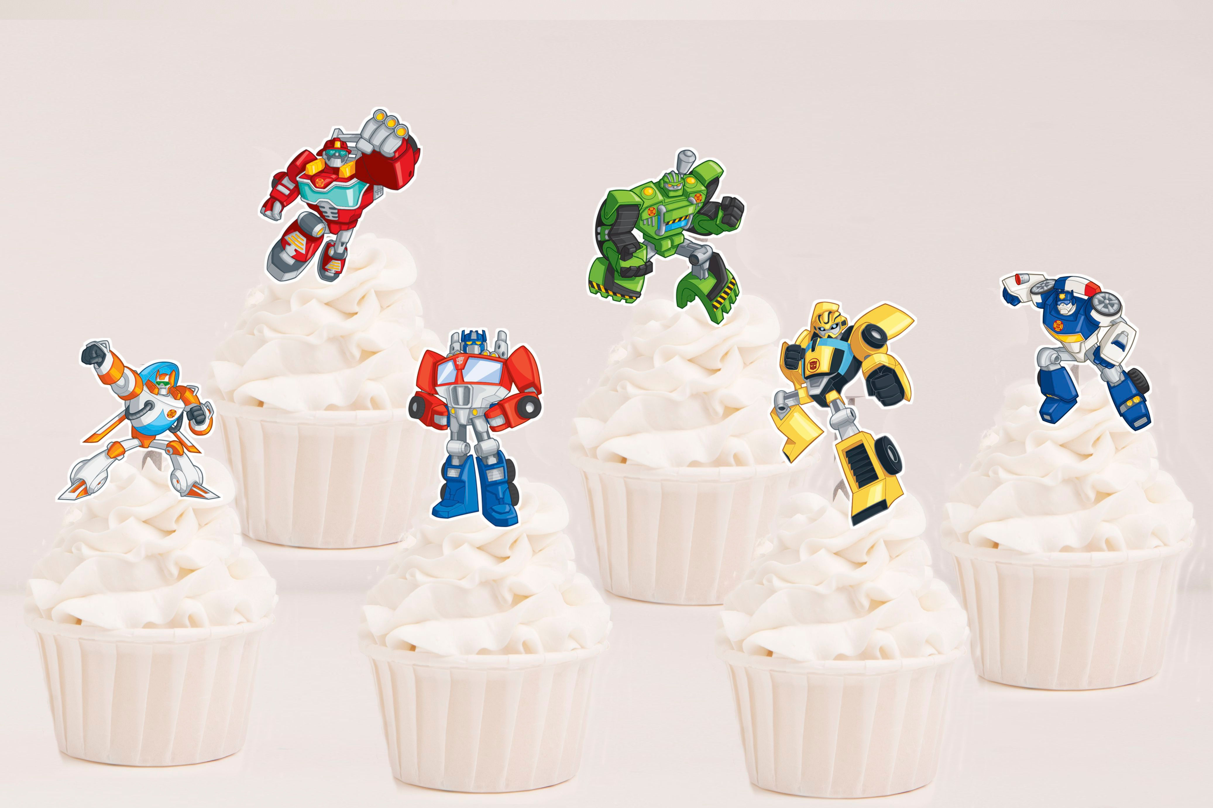 Toppers recortados Transformers Rescue Bots com robôs coloridos para decoração de cupcakes em festa infantil.