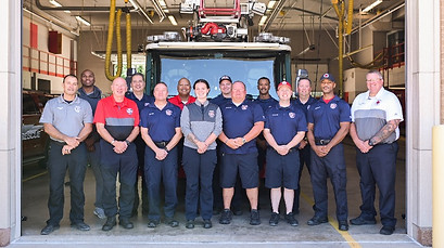 Black Jack Fire Protection District crew in their fire station in front of their fire protection vehicles in the Black Jack Missouri area