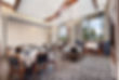 Restaurant dining room with tables set for service, and large windows open.
