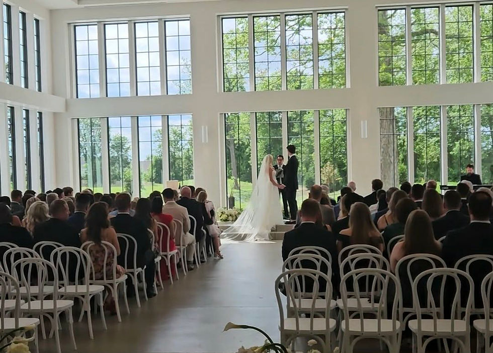 Bride and Groom at the alter exchanging vows before their first kiss that will be captured as a painting