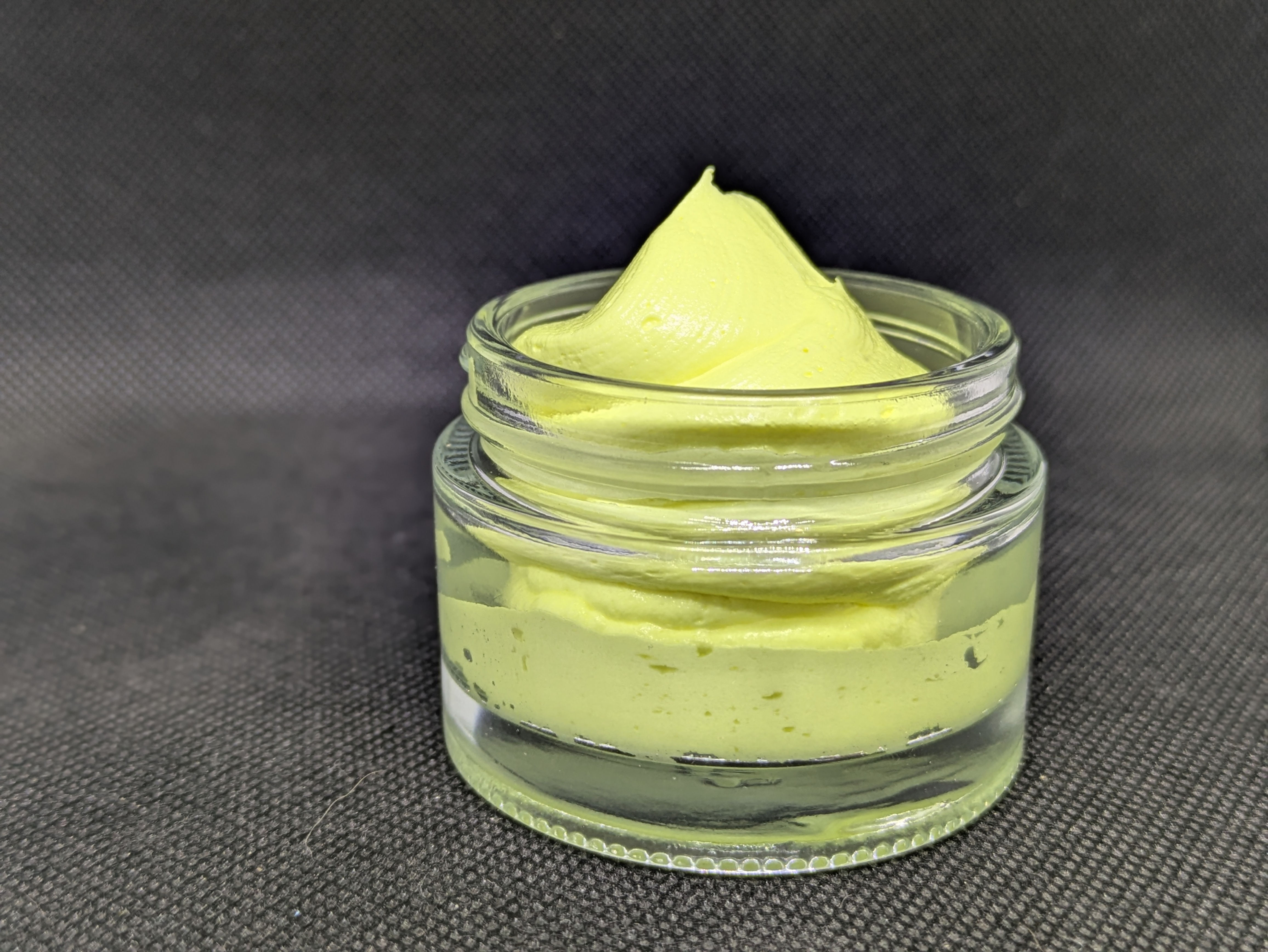 a clear jar of whipped sore muscle body butter
