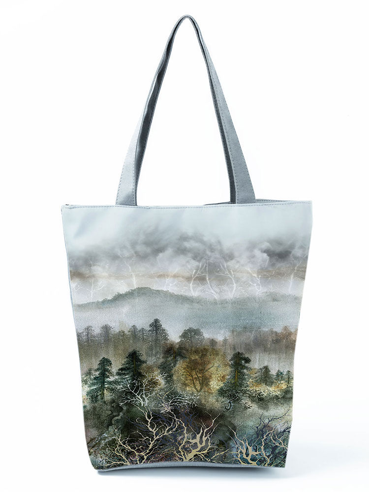 Tote bag with watercolor landscape painting of misty mountains.
