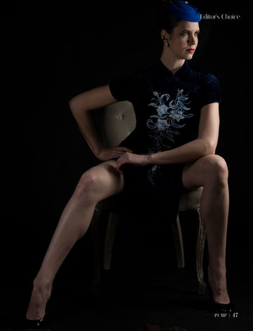 a woman in a blue hat sits on a chair with the words editor 's choice below her