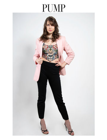 a woman in a pink jacket and black pants stands in front of a white background that says pump