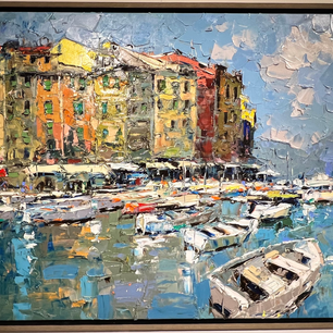 The harbor of Portofino in Italy with buildings in the background and boats in the water