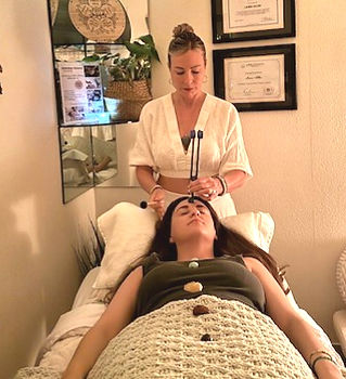 Laura Ela performing an In-Person Reiki session with tuning forks in Thousand Oaks, CA.