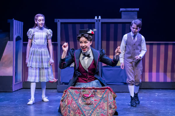 Mary Poppins on stage with children and magic bag