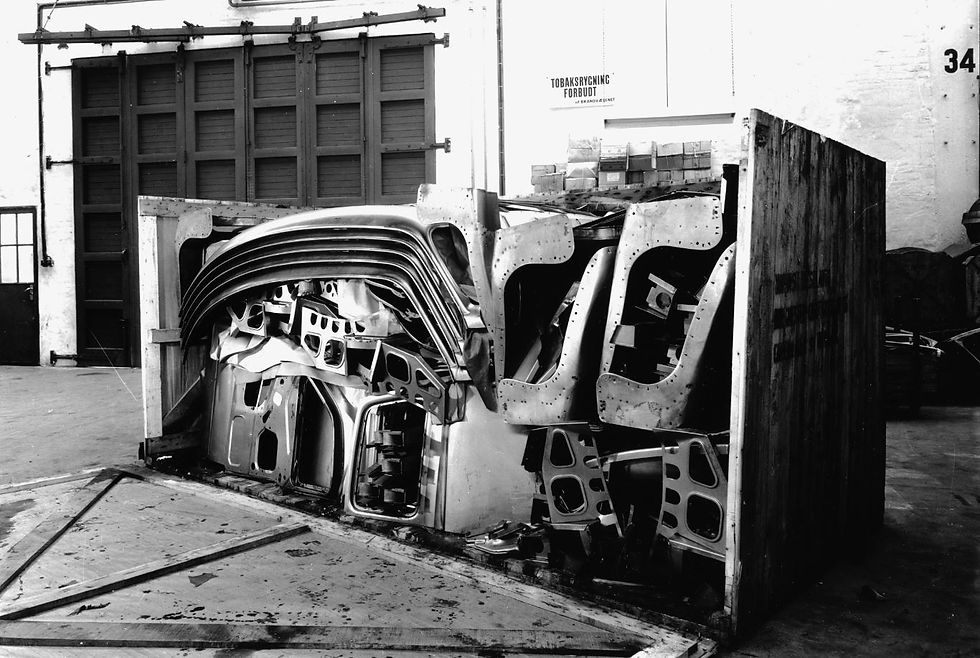 A crate of CKD body parts is opened.