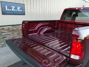 A red pick up truck parked in front of a building