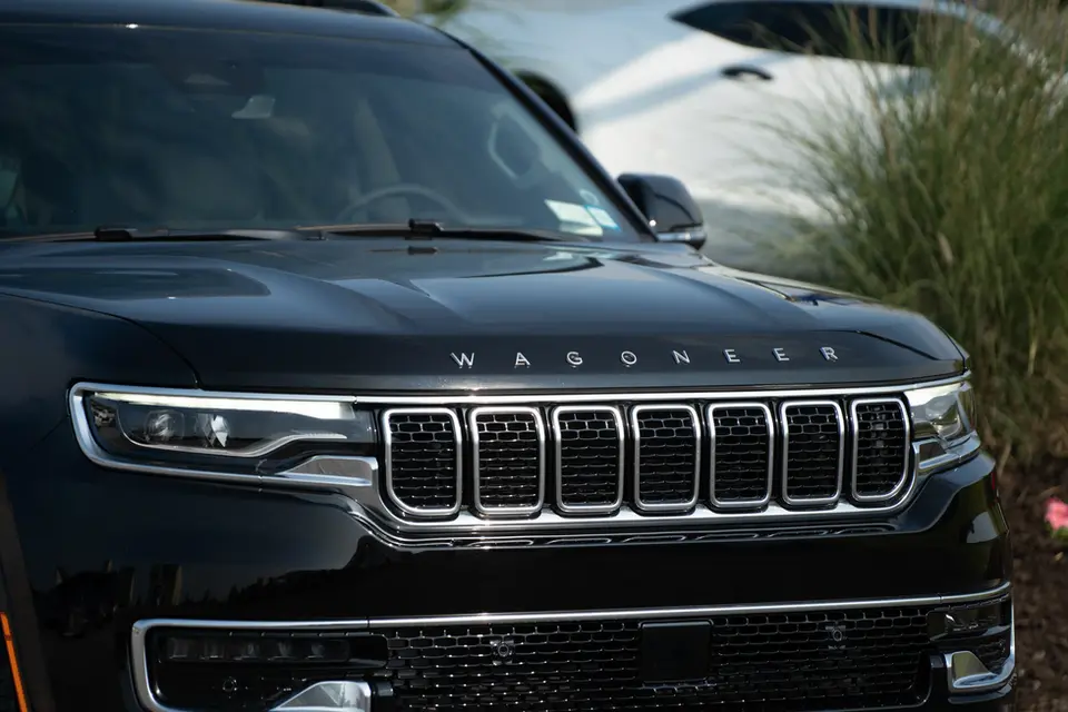 A black jeep is parked in a parking lot