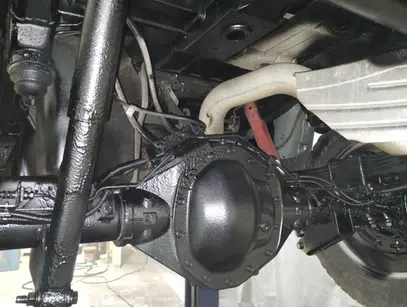 A close up of the front suspension of a vehicle