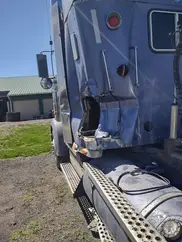 A large blue truck parked in a parking lot