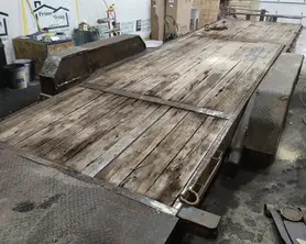 A flatbed trailer is parked in a garage