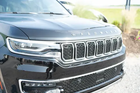 A black jeep is parked in a parking lot