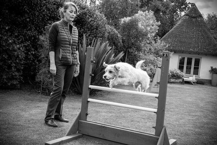 Caroline training one of her dogs to jump