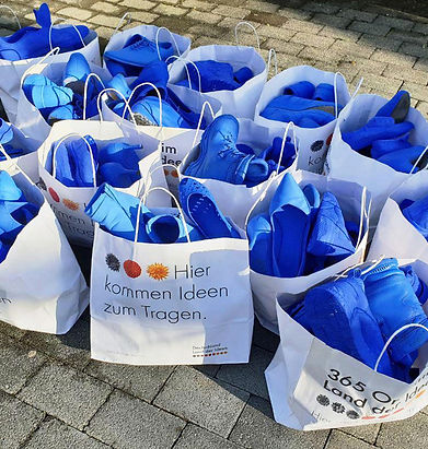 Bluedemonstration, shoes in white paper bags