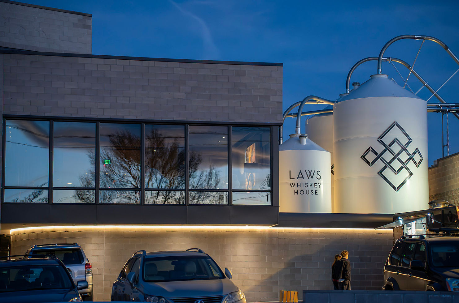 Laws Whiskey House real visitor and distilling facility in Denver, with branded production tanks.