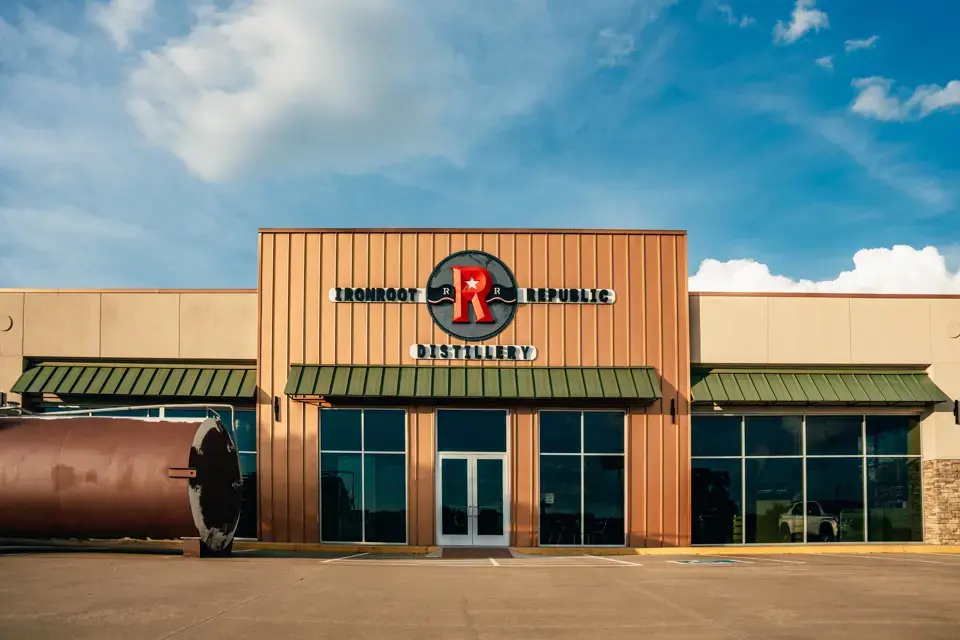 Ironroot Republic Distillery exterior and its signed entrance in Denison, Texas
