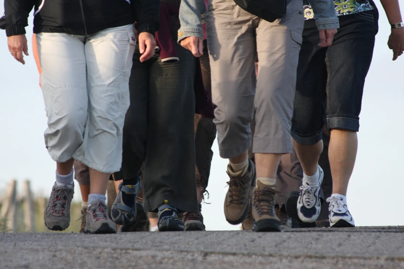 group of people walking from waist down