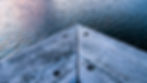 Detail of corner waterside pontoon with rippling water in the background