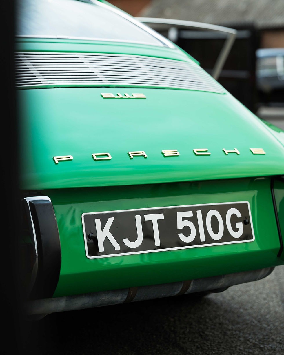 Image of the rear of a classic green Porsche 911
