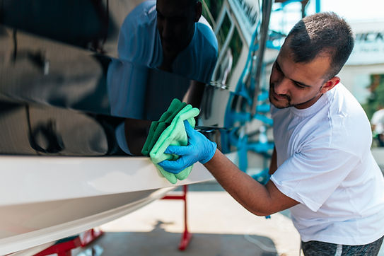 Boat maintenance - A man cleaning boat with cloth. .jpg