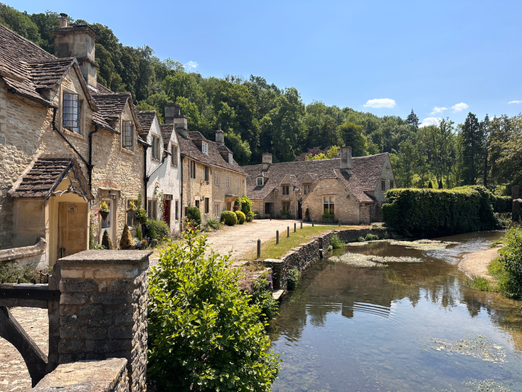 Stone cottages alongside the river in Castle Combe village, Wiltshire, in autumn