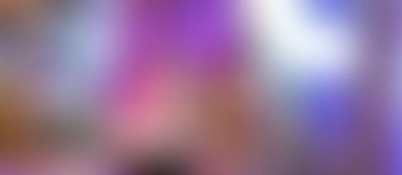 Elegant floral wedding backdrop with purple flowers, neon "Hafee" sign, a butterfly-shaped light, and plush rose chairs, exuding romance.